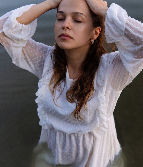 Serene woman with closed eyes enjoying a peaceful moment of deep relaxation